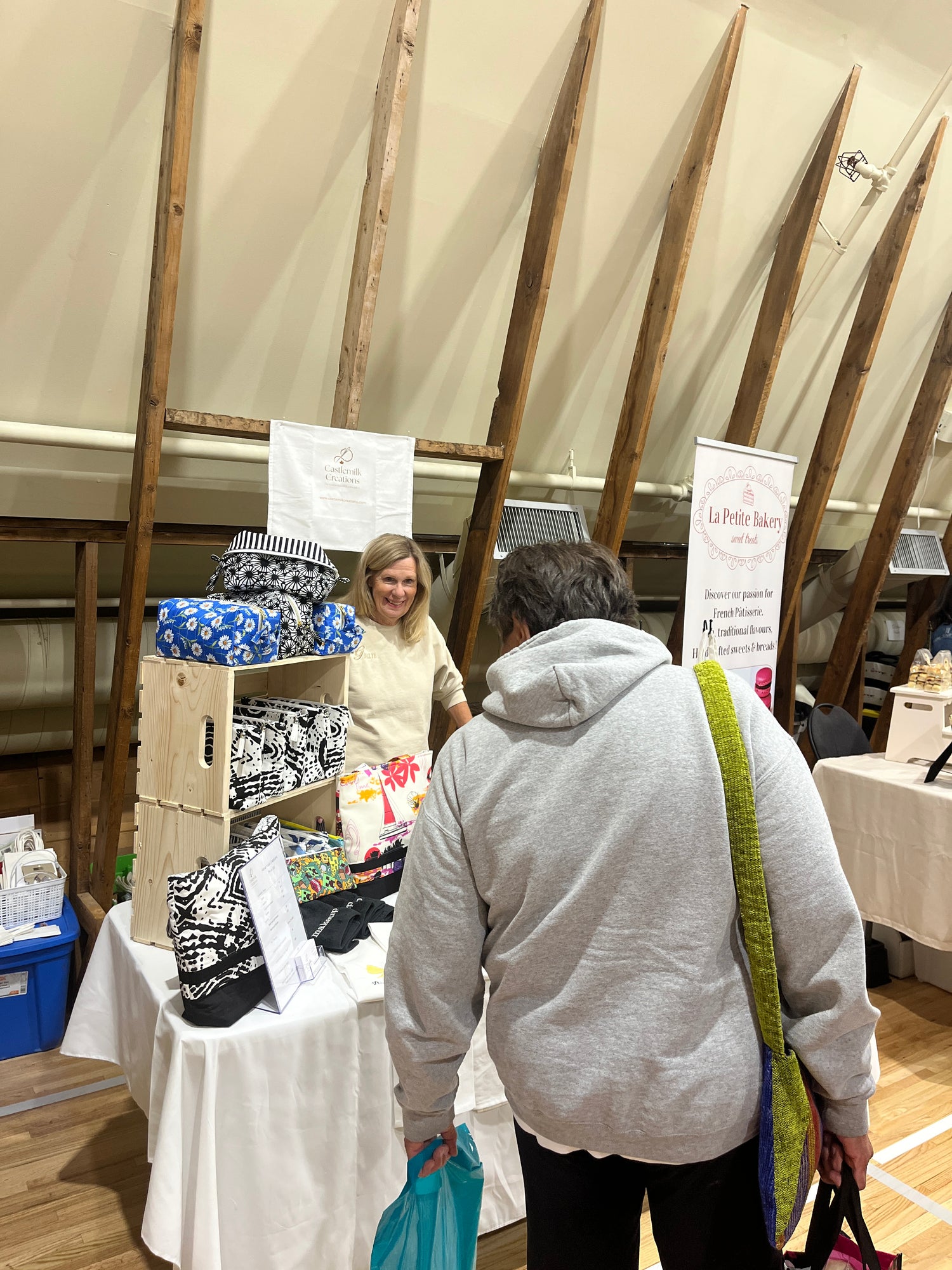 Evelyn Stewart, owner of Castlemilk Creations talking to a customer to sell embroidered products and personalized items