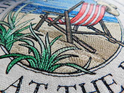 Embroidery of a beach scene with a red striped beach chair, grass, and text on 100% cotton tote bag..